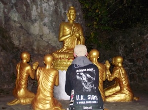 A punk pays his respects to the Buddha